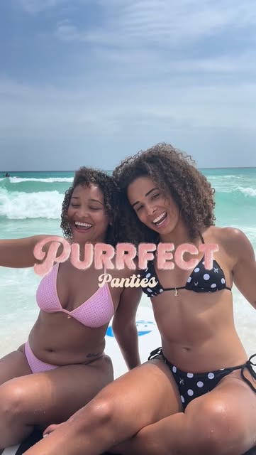 Two women wearing Purrfect Panties swimwear on a beach